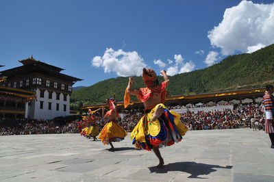 People dancing against sky