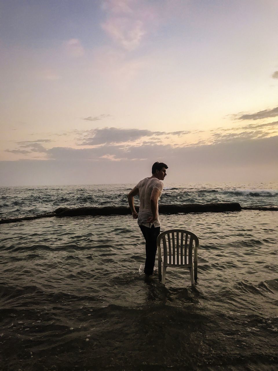 sea, sunset, one person, water, nature, sky, standing, beauty in nature, scenics, full length, real people, tranquil scene, horizon over water, cloud - sky, tranquility, beach, leisure activity, outdoors, lifestyles, men, day, people