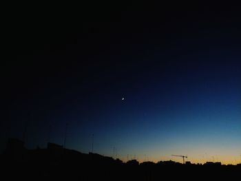 Low angle view of silhouette moon against sky at night