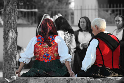 Rear view of people sitting outdoors