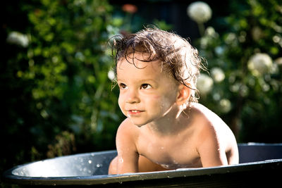 Portrait of shirtless boy in bathroom