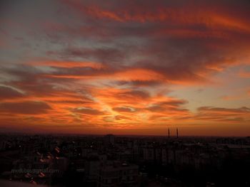 High angle view of townscape against orange sky