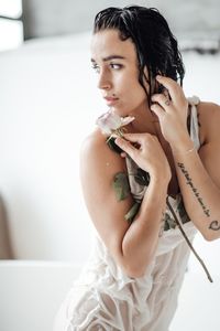 Beautiful woman sitting in bathtub