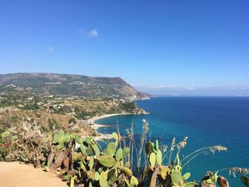 Scenic view of sea against clear blue sky