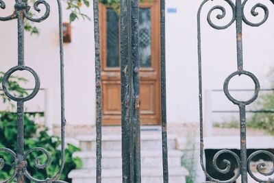 Close-up of chain hanging on metal gate