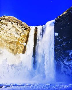 Scenic view of waterfall against clear sky