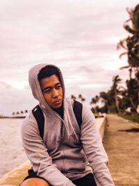 Portrait of mid adult man sitting on beach