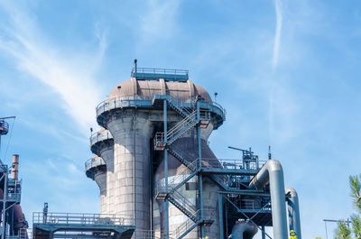 Low angle view of factory against sky