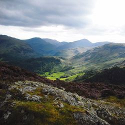 Scenic view of valley and mountains against sky