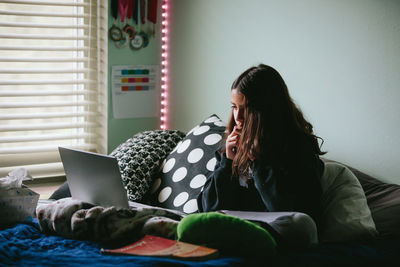 Tween girl attends a zoom meeting for class during quarantine