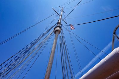 Low angle view of sailboat against clear blue sky