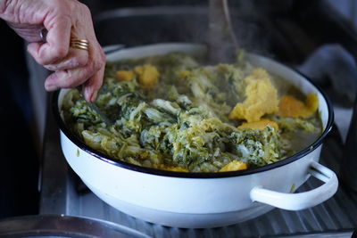 Close-up of person preparing food in kitchen