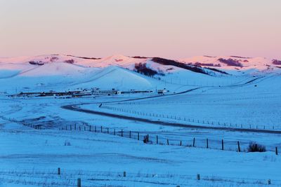 Scenic view of snowcapped mountains against clear sky during winter