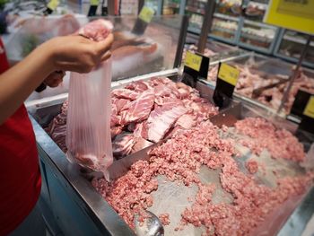 Midsection of person preparing food at market stall