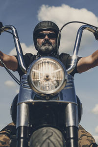 Low angle view of man riding bicycle