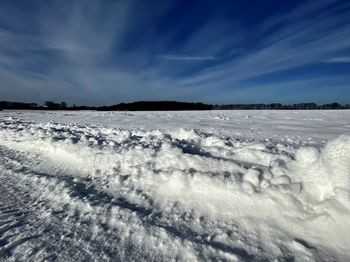 Snow covered land against sky