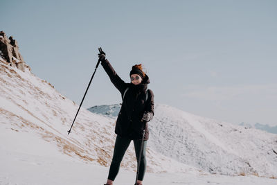 Low angle view of man standing on snow