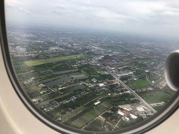 Aerial view of cityscape seen through airplane window