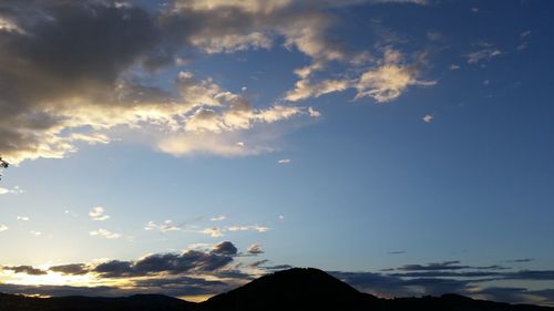 Scenic view of mountains against cloudy sky