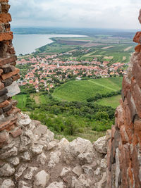 View through the devicky ruin window into landscape of nove mlyny dam, pavlov region. czechia