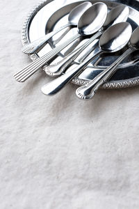 High angle view of spoons and plate on table