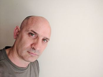 Close-up portrait of happy man against white background