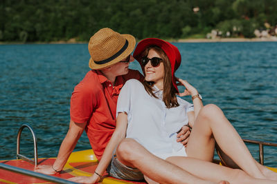 Midsection of woman sitting in boat against sea