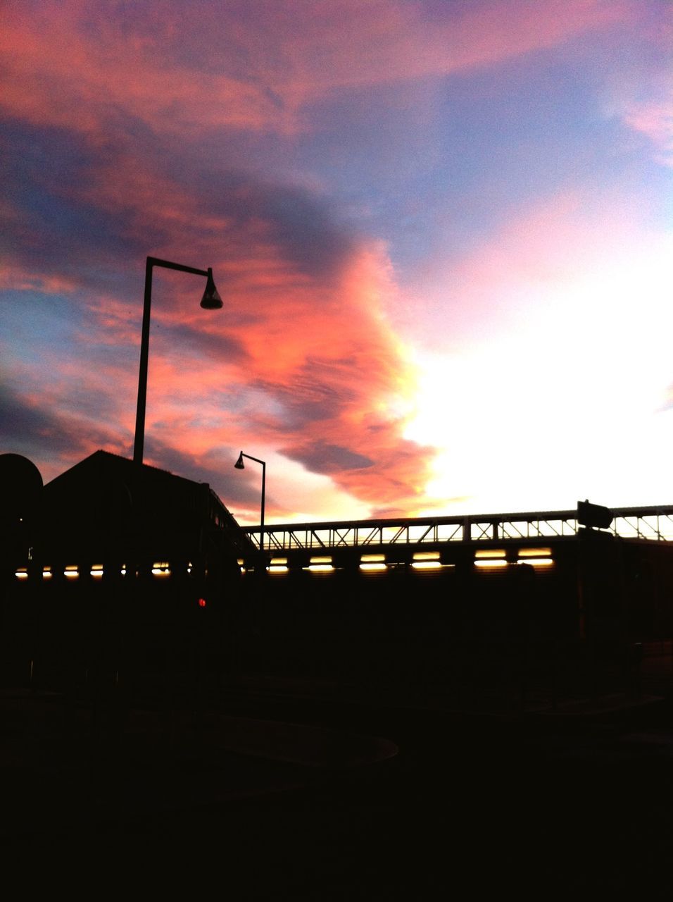 sunset, sky, silhouette, street light, cloud - sky, orange color, connection, transportation, built structure, bridge - man made structure, architecture, dusk, railing, lighting equipment, cloud, nature, illuminated, cloudy, low angle view, road