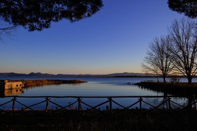 Scenic view of lake against clear blue sky