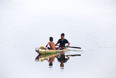 Men sitting in sea