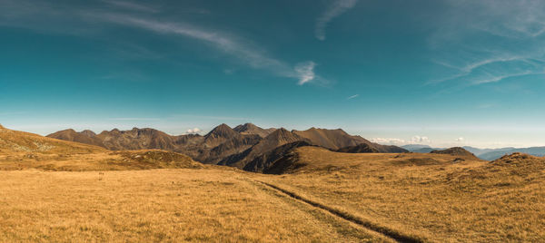 Panoramic view of landscape by mountains against sky