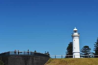 Low angle view of lighthouse against clear blue sky