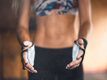 Midsection of woman hands covered with powder