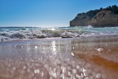 Scenic view of sea against clear blue sky