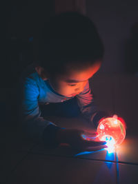 Boy playing with illuminated lights