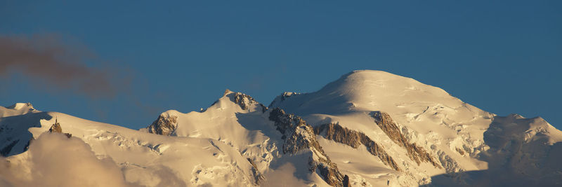 Scenic view of snow covered mountains against sky