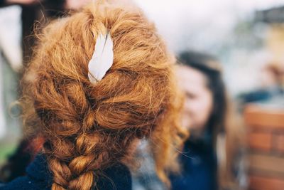 Rear view of redhead girl with braided hair