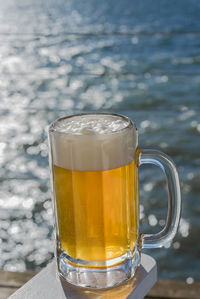 Beer glass against sea