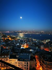 High angle view of illuminated city buildings against clear sky