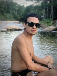 Portrait of handsome young man in swimming pool