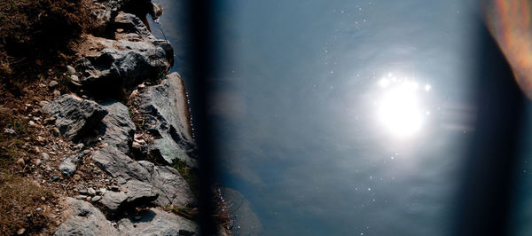 High angle view of rock formation in sea against sky