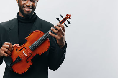 Man playing violin against white background