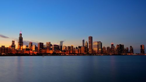 View of city at waterfront during sunset