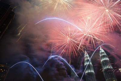 Low angle view of firework display at night