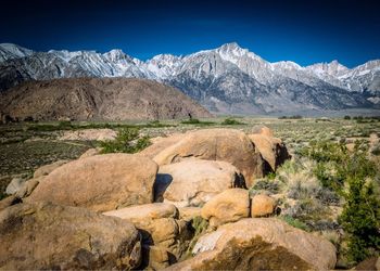 Scenic view of mountains against blue sky