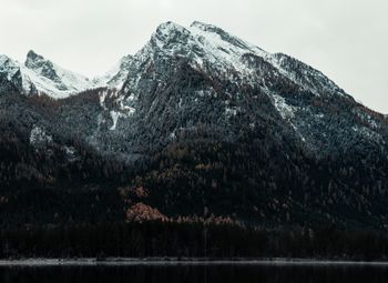 Scenic view of lake by mountains against sky