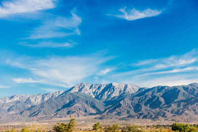 Scenic view of mountains against cloudy sky