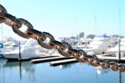 Close-up of chain against blue sky