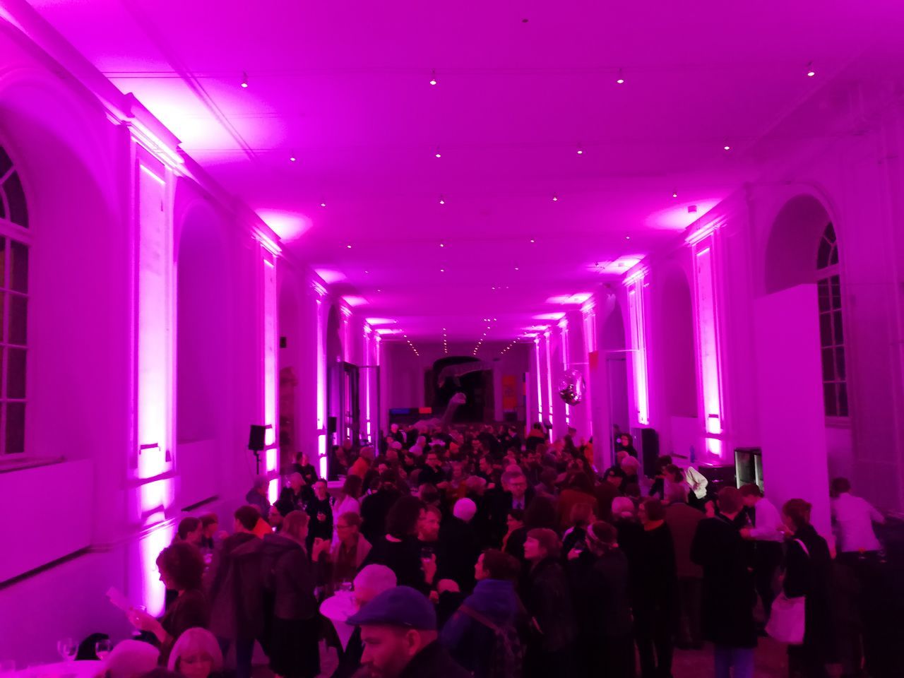 real people, crowd, large group of people, group of people, illuminated, men, indoors, women, pink color, event, architecture, arts culture and entertainment, adult, lifestyles, enjoyment, nightlife, leisure activity, togetherness, party - social event, ceiling, architectural column, purple, stage