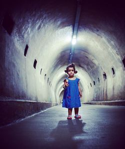 Full length of woman standing in tunnel